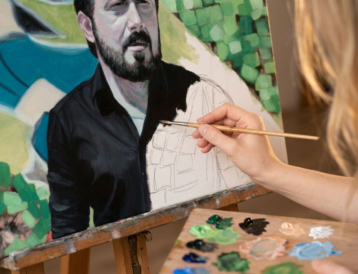 An oil portrait of Rino Gattuso in progress on the easel, the brush on his dark shirt and the palette in the foreground.